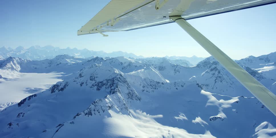 Aerial view of snow capped mountains seen from a plane