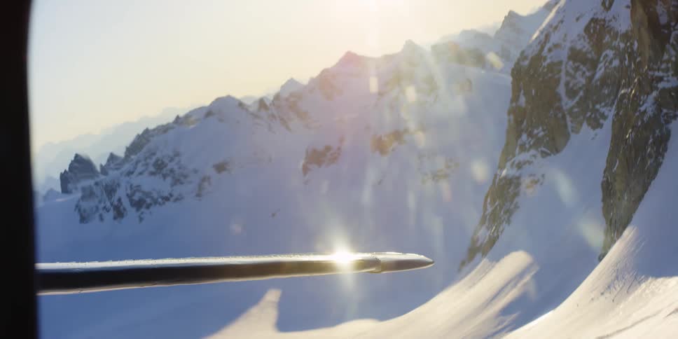A plane is flying close to the mountain top