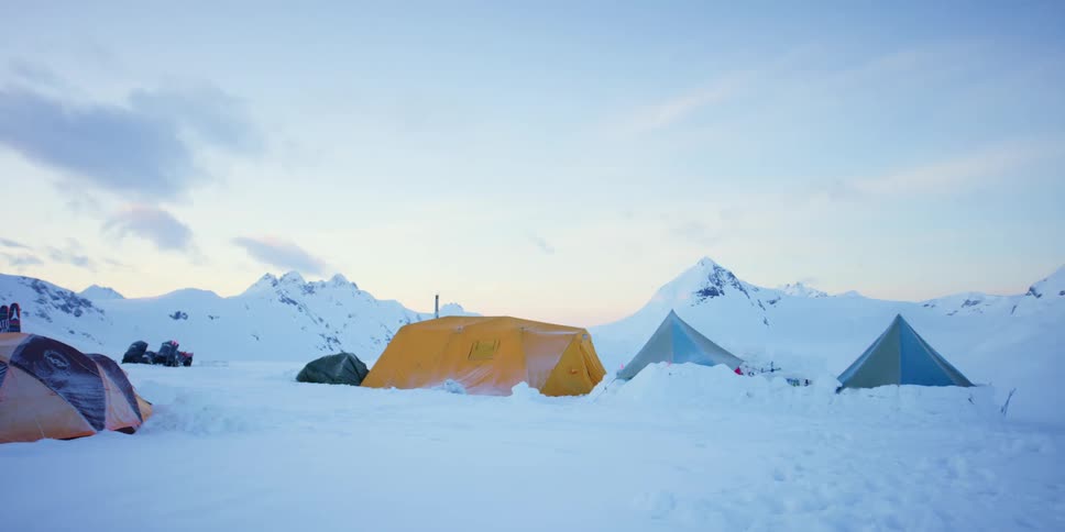 Tents and campsite in snow in mountains