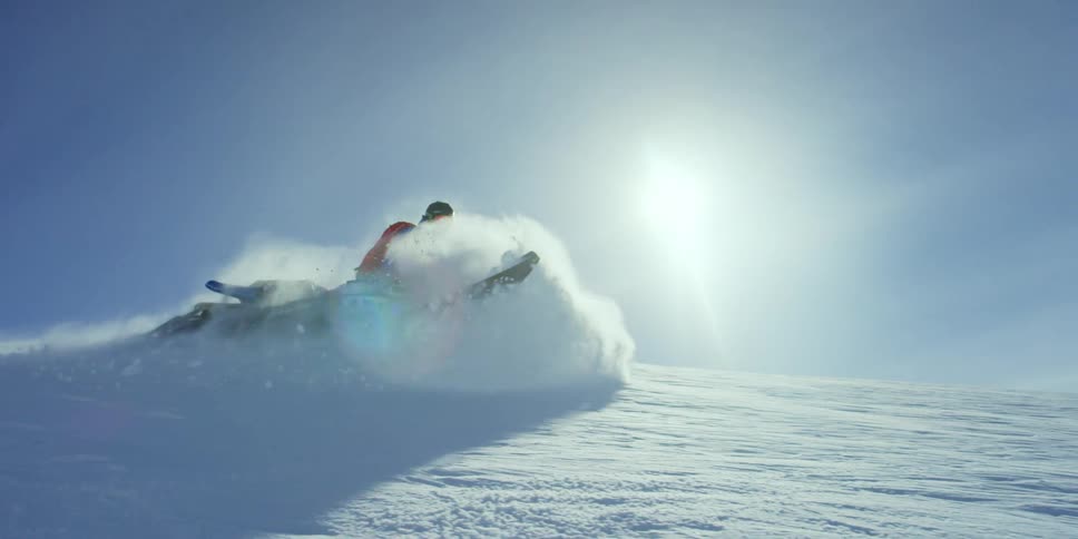 A person is riding a snowmobile on the slope
