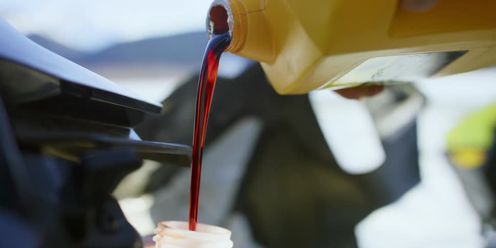 A motorcycle gets topped with oil as its parked near a canyon