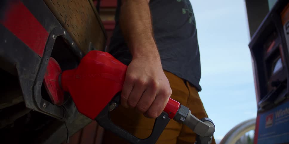A man pumps gas in to his vehicle