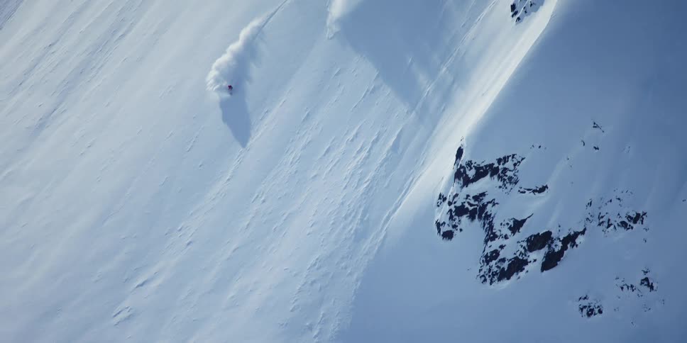 Person skiing down steep mountain slope