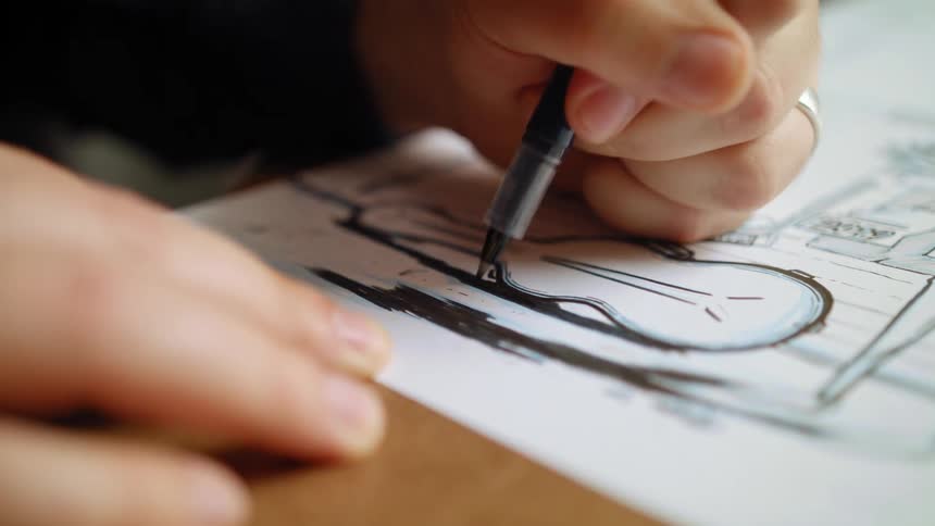 Person wearing ringinks drawing with black pen