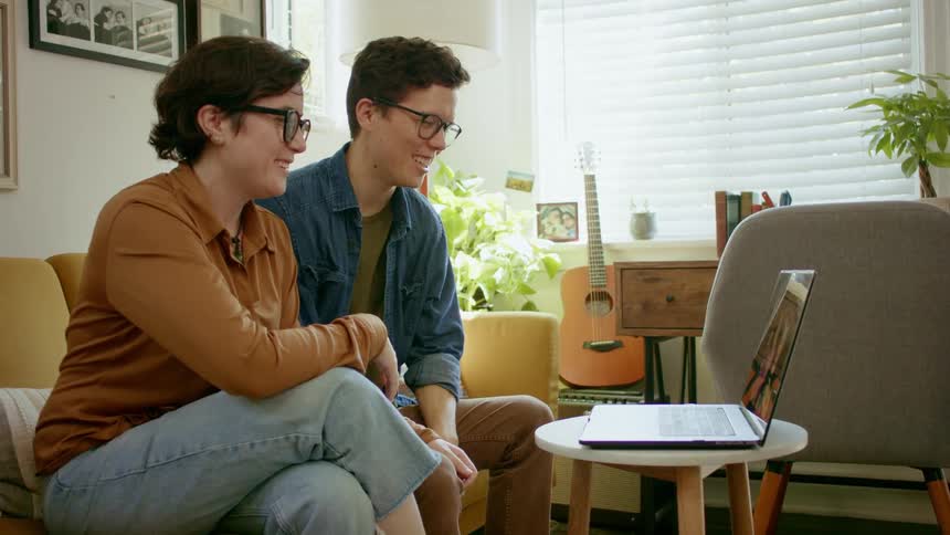 Young couple having zoom meeting with relatives