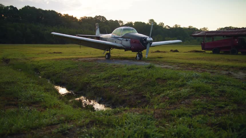 Water fills small depression paralleling field airplane occupies