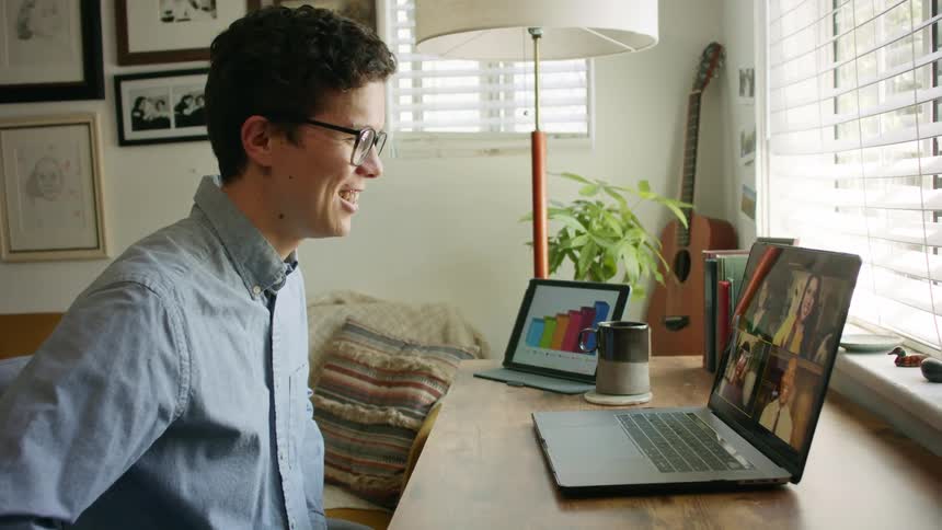 A man talking to people on a laptop