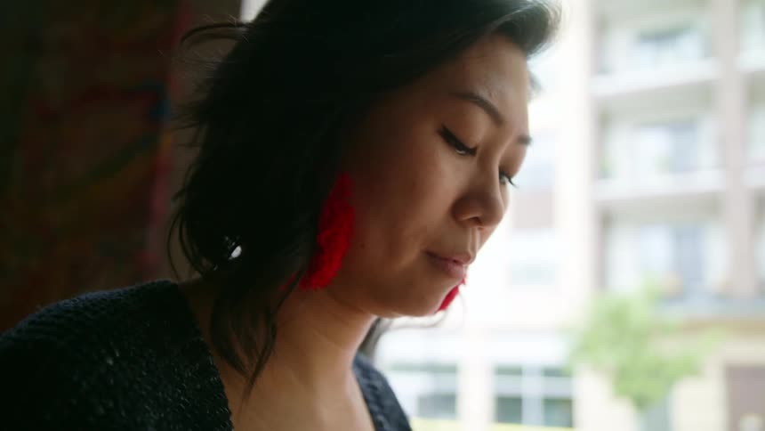 A woman in a restaurant making dumplings