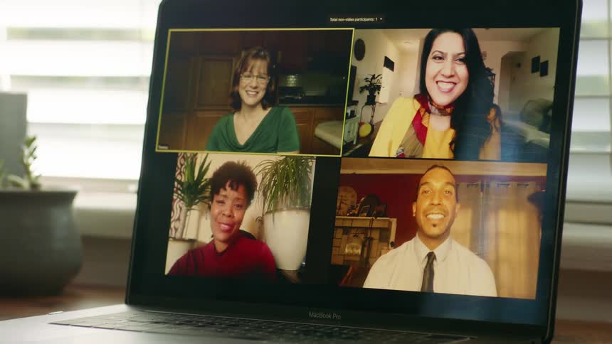 People having a video meeting show on laptop sitting near blind covered video