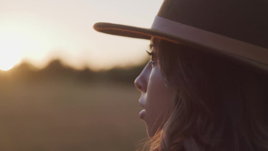 A teenage girl outside looks off in to the distance