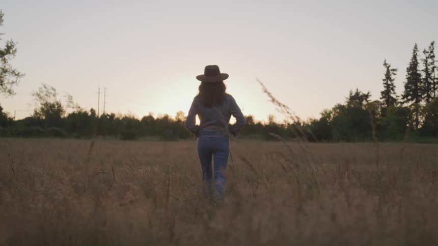 A woman is walking through a rural area
