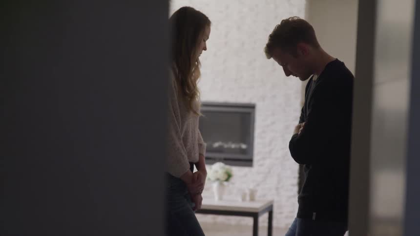 A man and woman talking and looking sad
