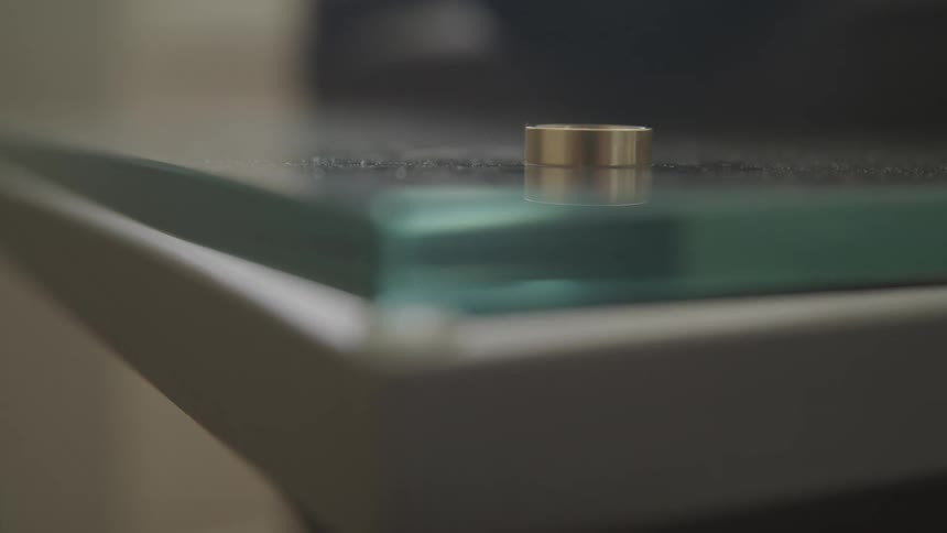 The corner of a metal and glass table with dust