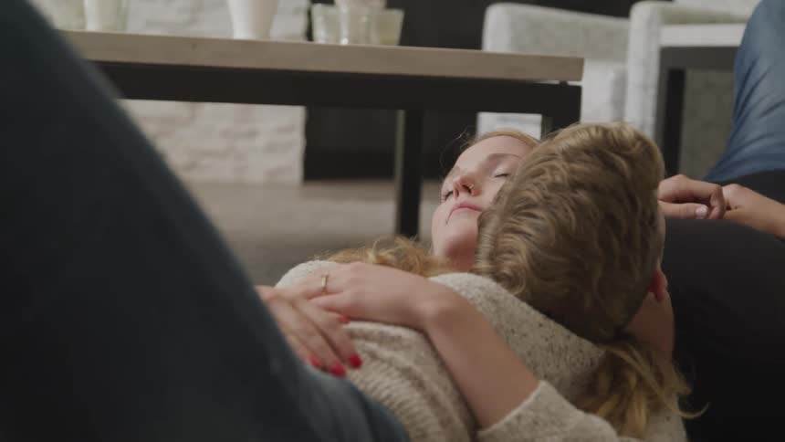 A man and woman nap together and sitting back to back and resting their heads on each others shoulder