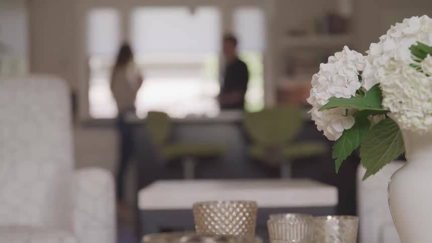 A man and woman talking in their home