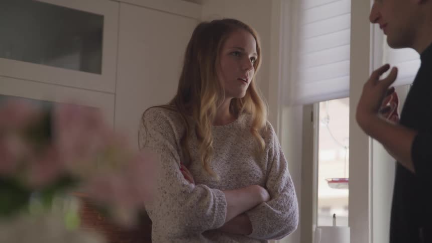A teenage boy and girl have a disagreement in a home