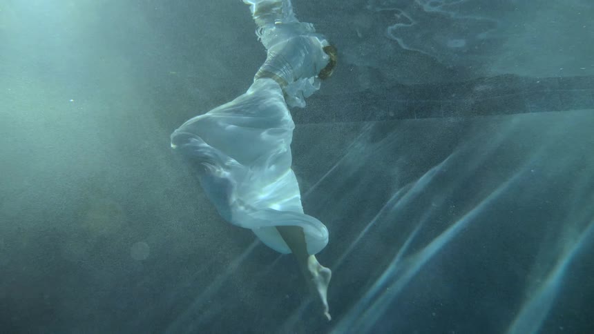 A woman in a dress treading water
