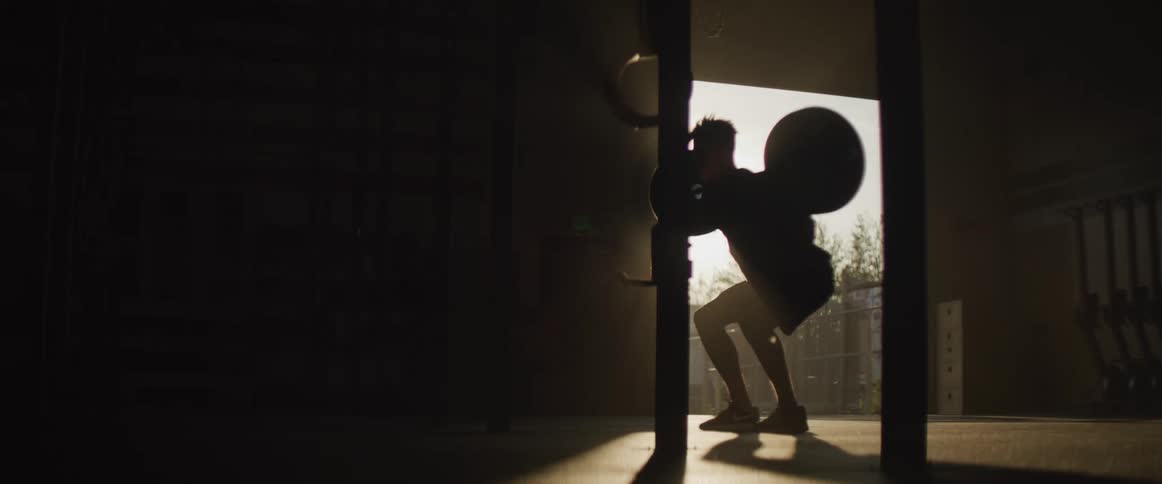 A man is lifting weights in a gym