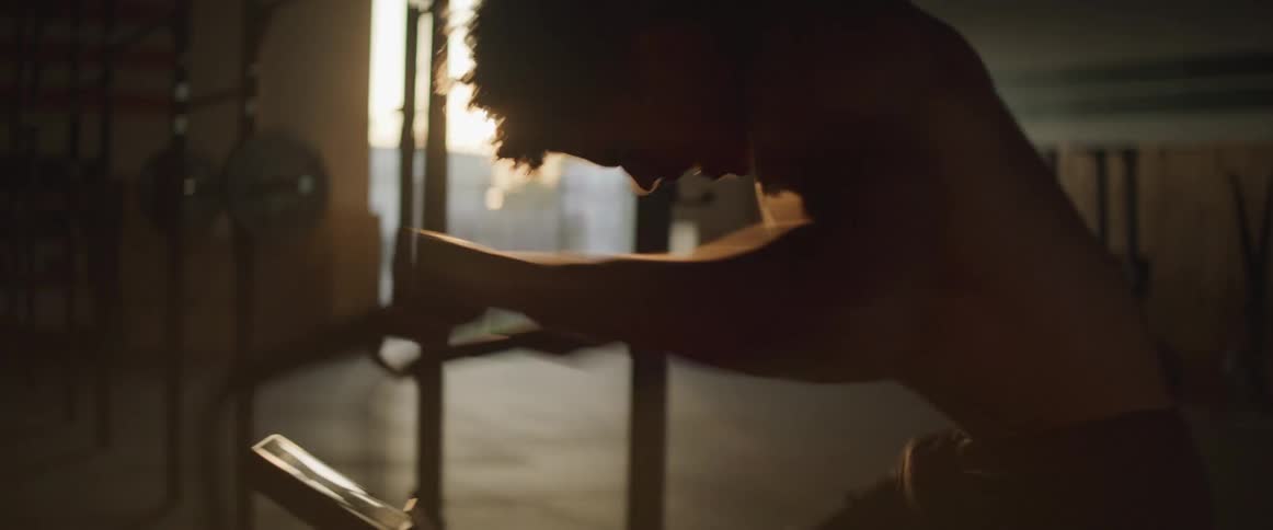 Young man works out on stationary bike in gym
