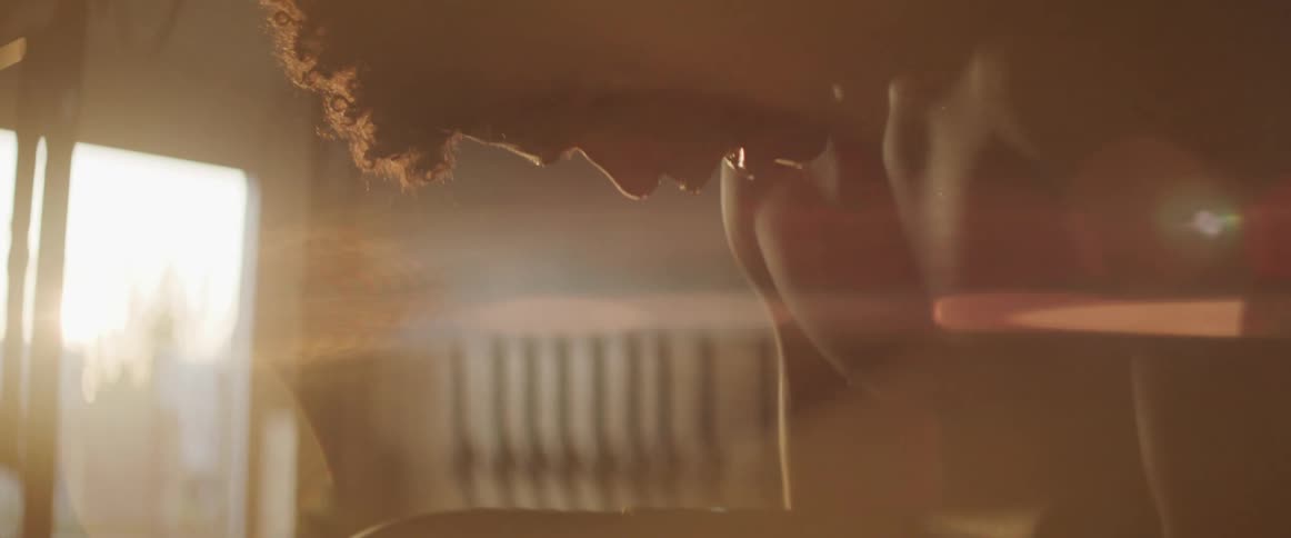 A young muscular man drips sweat as he breaths heavily in a gym