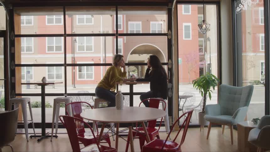 Friends talking and having coffee at a local coffee house