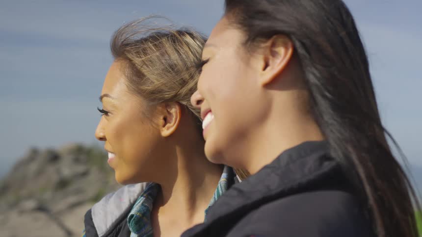 Two women are outdoors and smiling