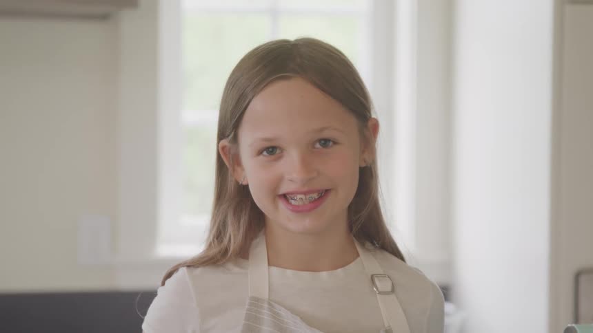 A girl is smiling in her home