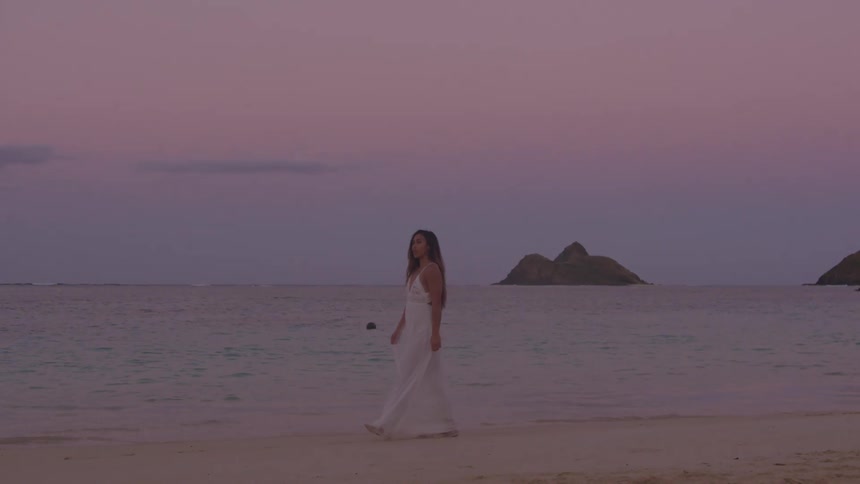 A young woman walking on the beach
