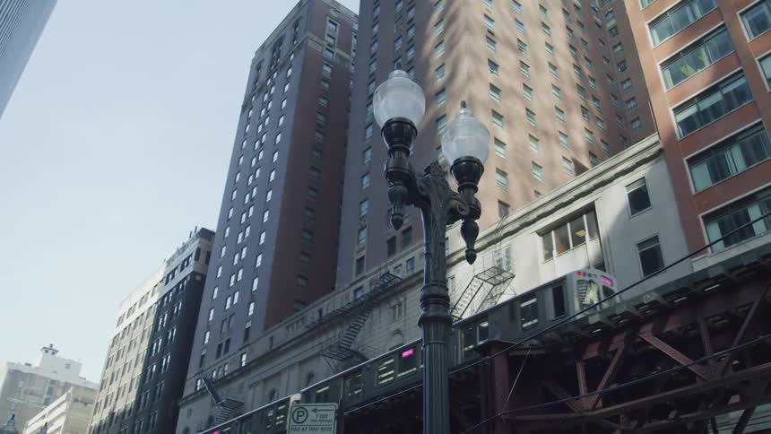 A train driving past apartment buildings in a city