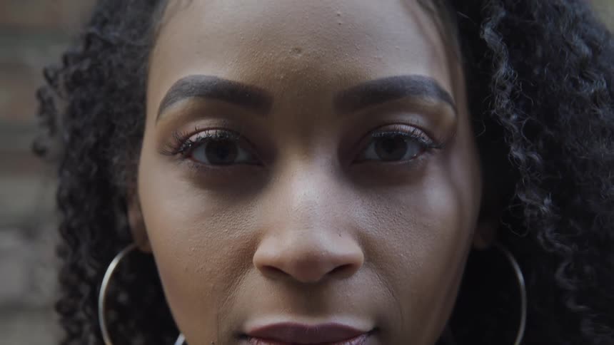 A closeup view of a womans face is displayed