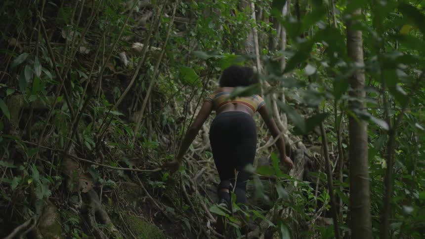 A woman is hiking through a forest in spring