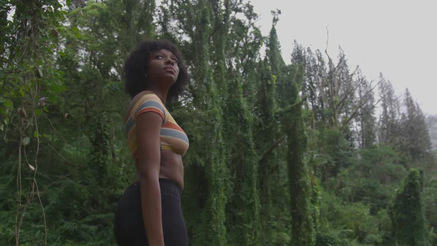 A woman is standing in the forest