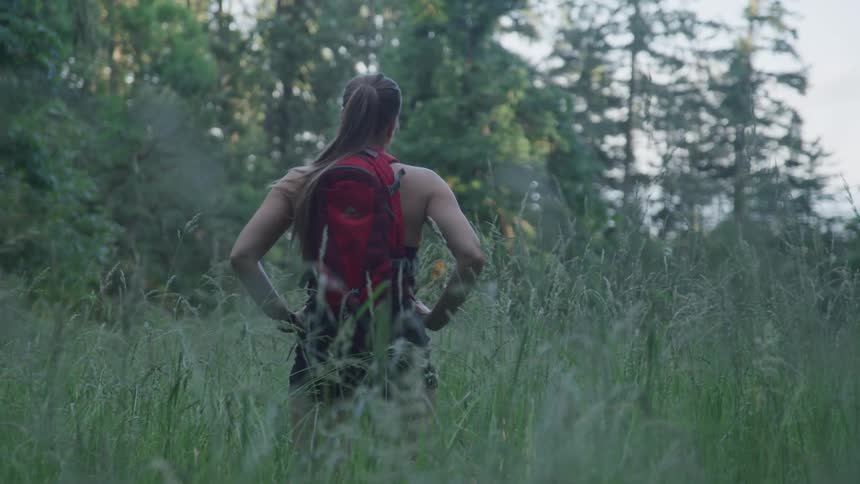 A girl is hiking through the woods
