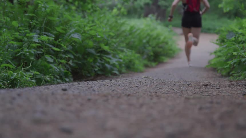 A young woman running on a trail