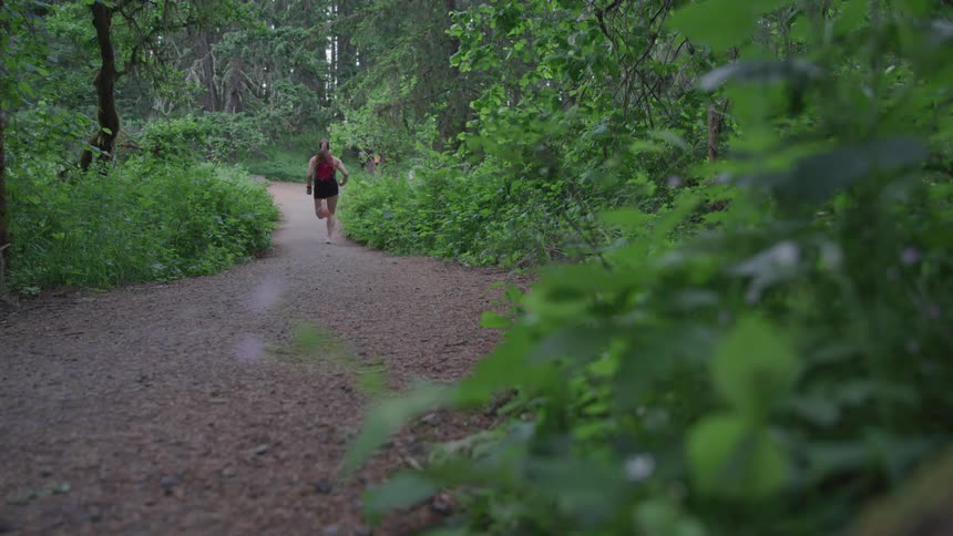 A female running on a path in the woods