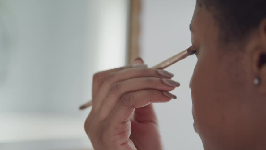 A woman putting eyeshadow on