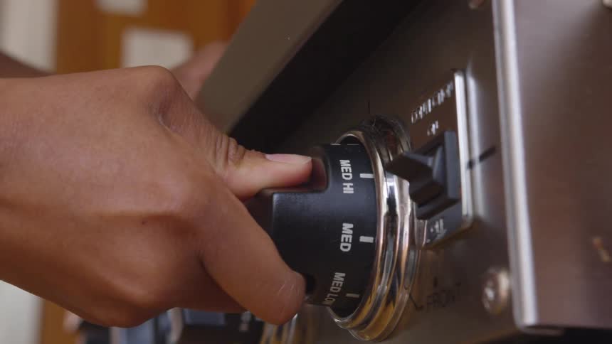 Turning the oven knob to hi