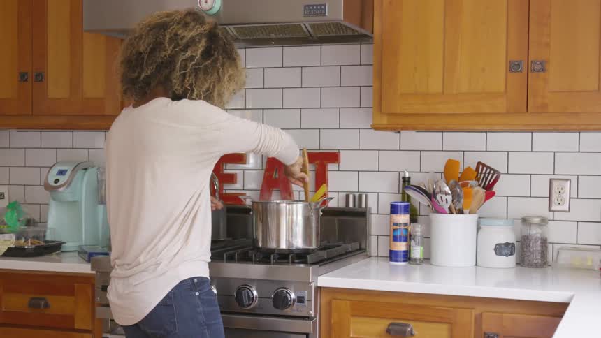 Woman cooking pasta on the kitchen at home