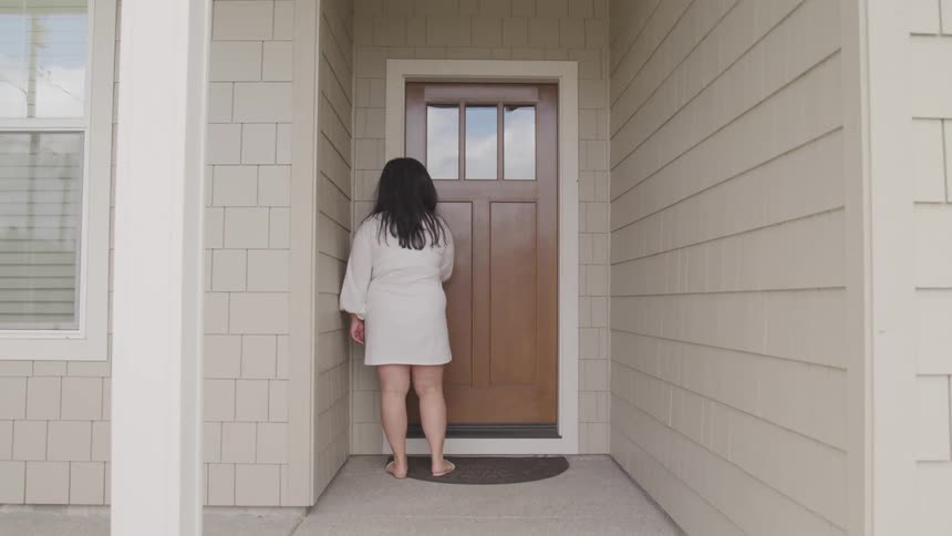Woman with a white dress enters the home