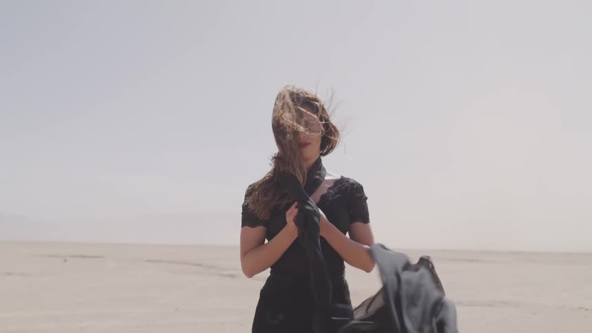 A woman is standing in the desert