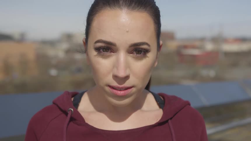 Close up of a young woman face near a small town