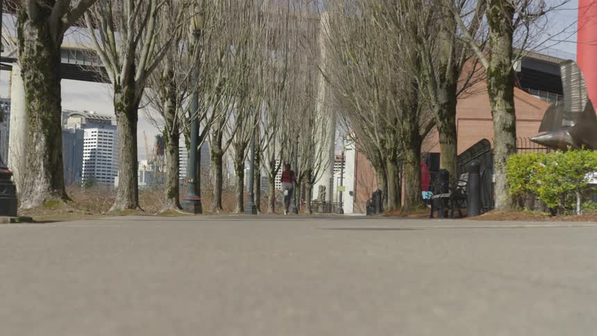 Young fit woman in sports clothes runs exercising on the city
