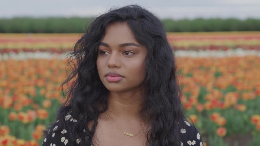 A teenage girl in a field of flowers