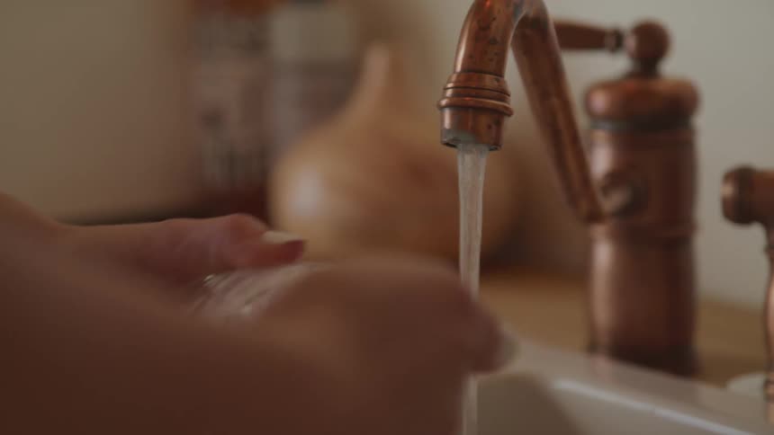 A person is washing dishes in the kitchen