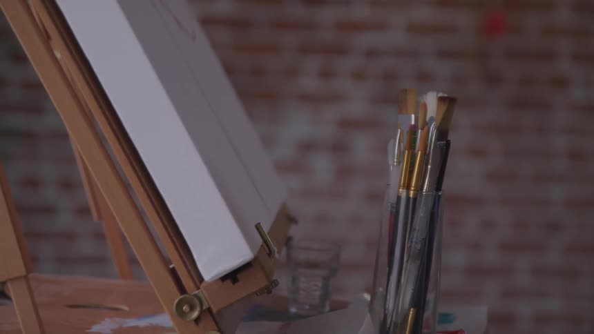 A canvas and paint brushes