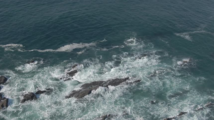 An aerial view of an ocean is displayed