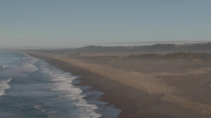 Ocean waves are moving towards the coast of the beach