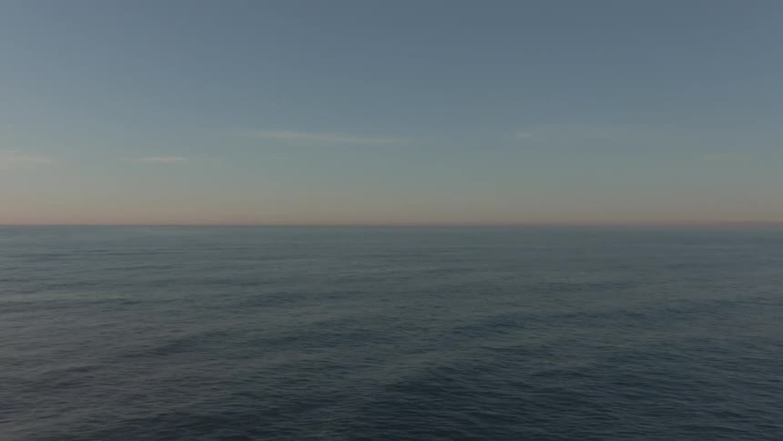 An aerial view of an ocean is displayed