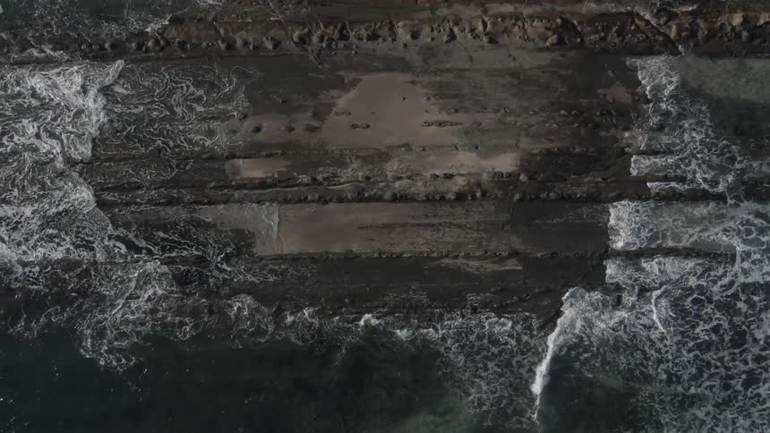 Aerial view of waves rolling in to the shore