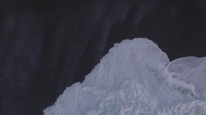 An aerial view of an ocean is displayed